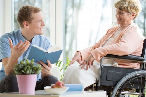 Care Worker Smiling At Elderly Woman